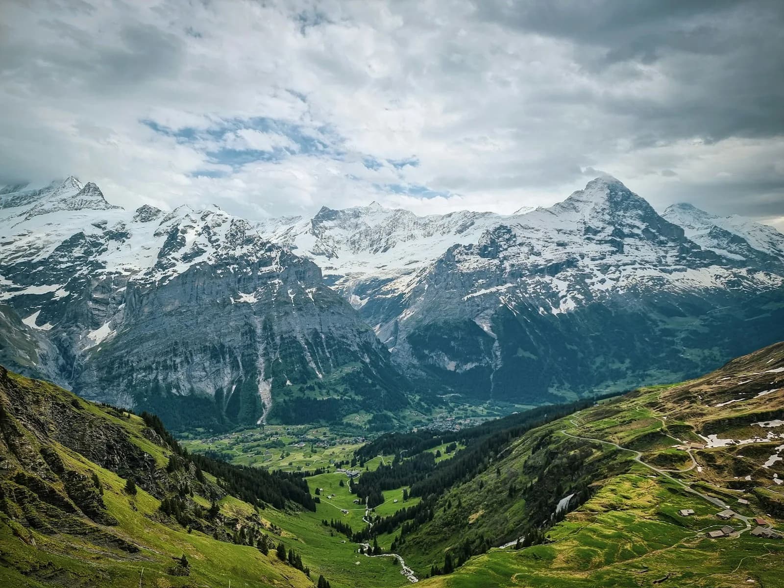 A Jungfrau Railway train traveling through the Swiss Alps toward Jungfraujoch